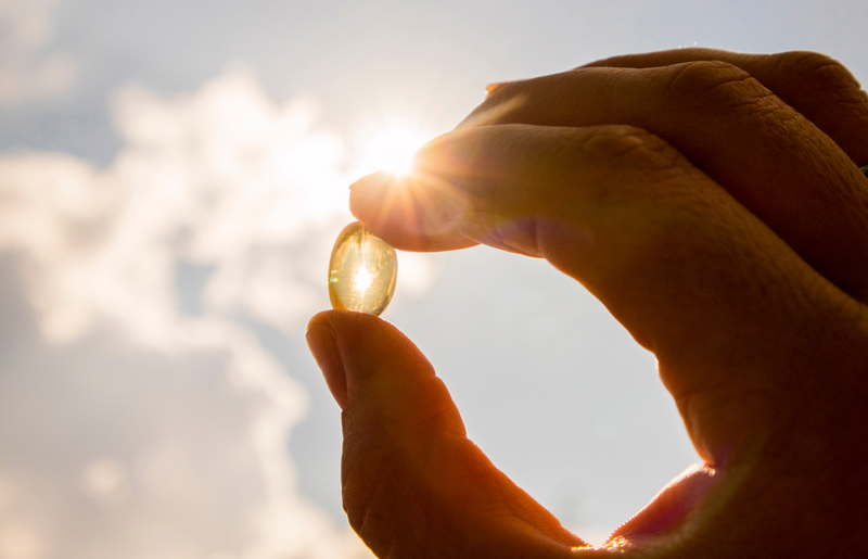 vitamin D supplement in front of the sun