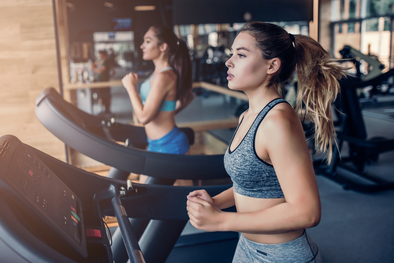 woman on cardio machines at the gym