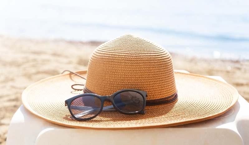 hat and sunglasses on beach