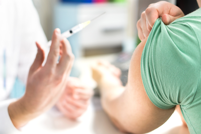 woman getting immunization at local pharmacy