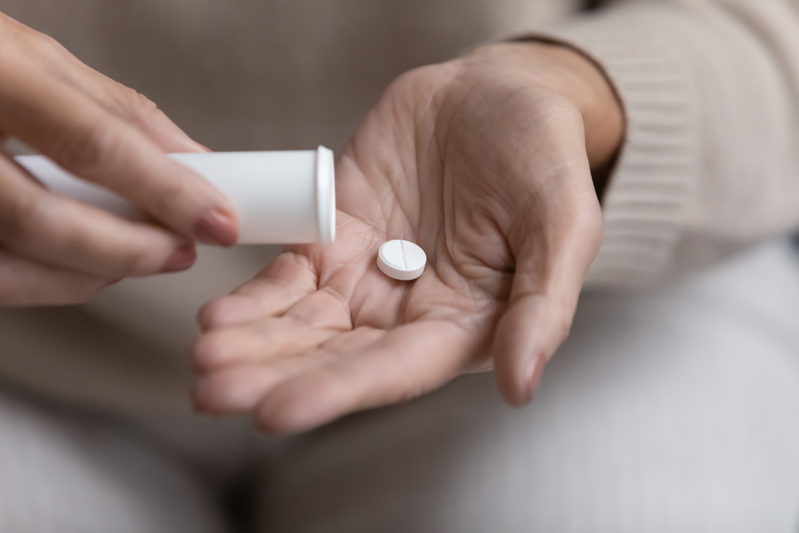 Woman taking a supplement to help reduce stress