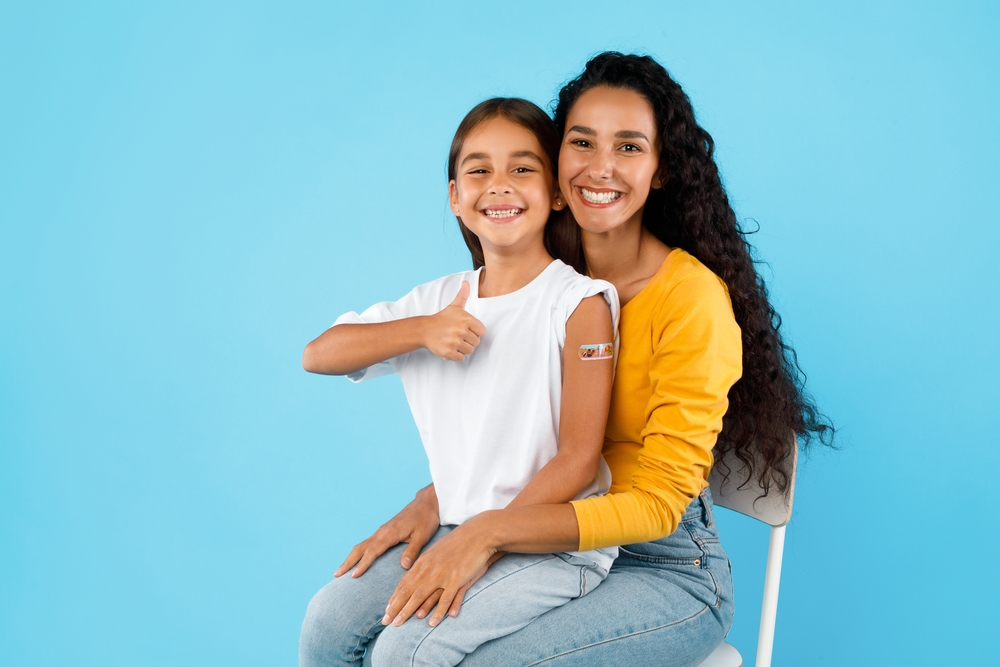 mom and daughter smiling after vaccine