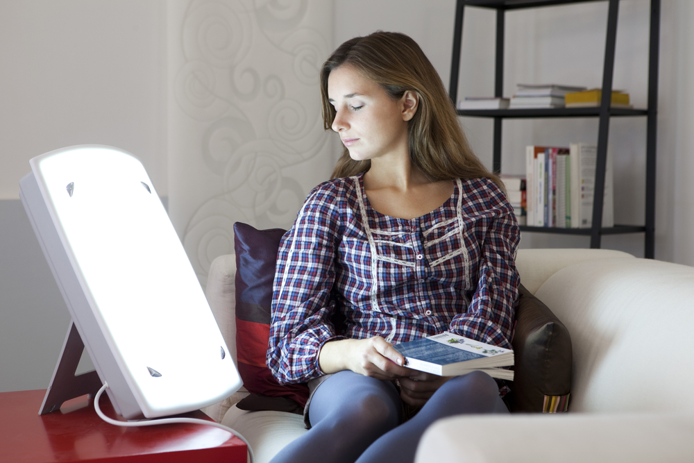 young woman with SAD using light therapy as treatment