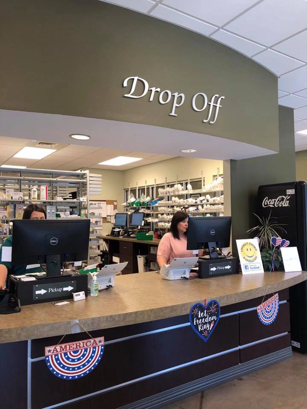 pharmacists at prescription drop off counter