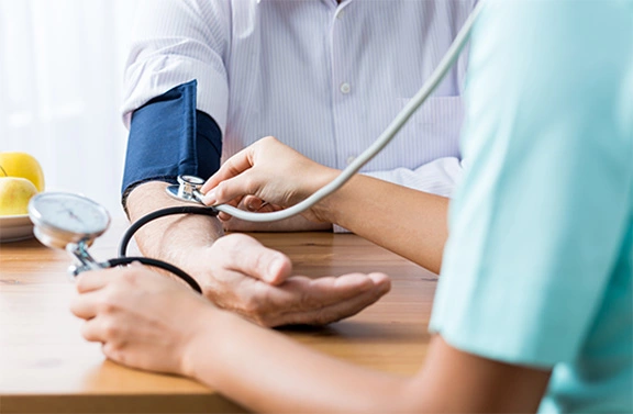 Pharmacist taking patient’s blood pressure