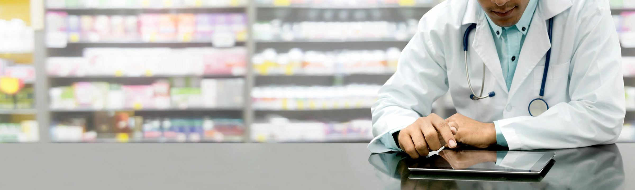 Pharmacist with iPad entering prescriptions