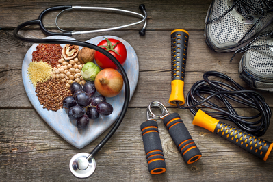 healthy snacks on a heart shaped plate alongside workout equipment