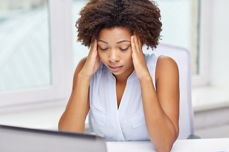 woman with her head in her hands stressed