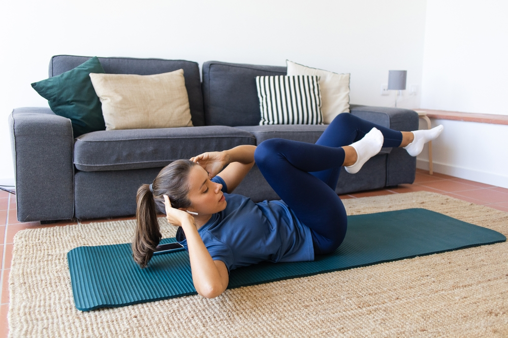 woman doing crunches in living room