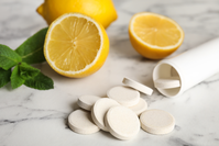 vitamin C chewable tablets next to lemons